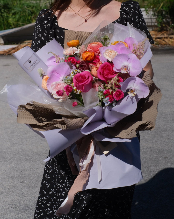colourful bouquet with pink roses and orchids