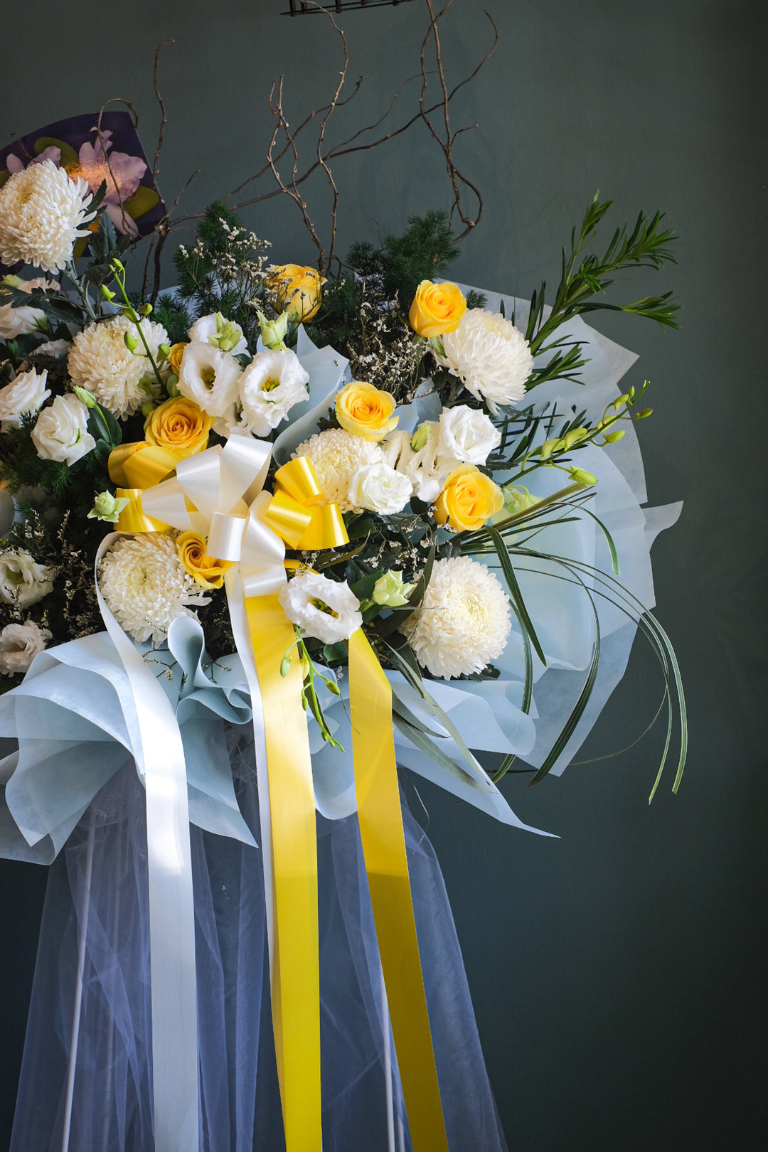 Delicate the full and abundant life of your loved one with this profusion of yellow and white combinations together with soothing blue. For same day condolences flowers delivery in Penang.