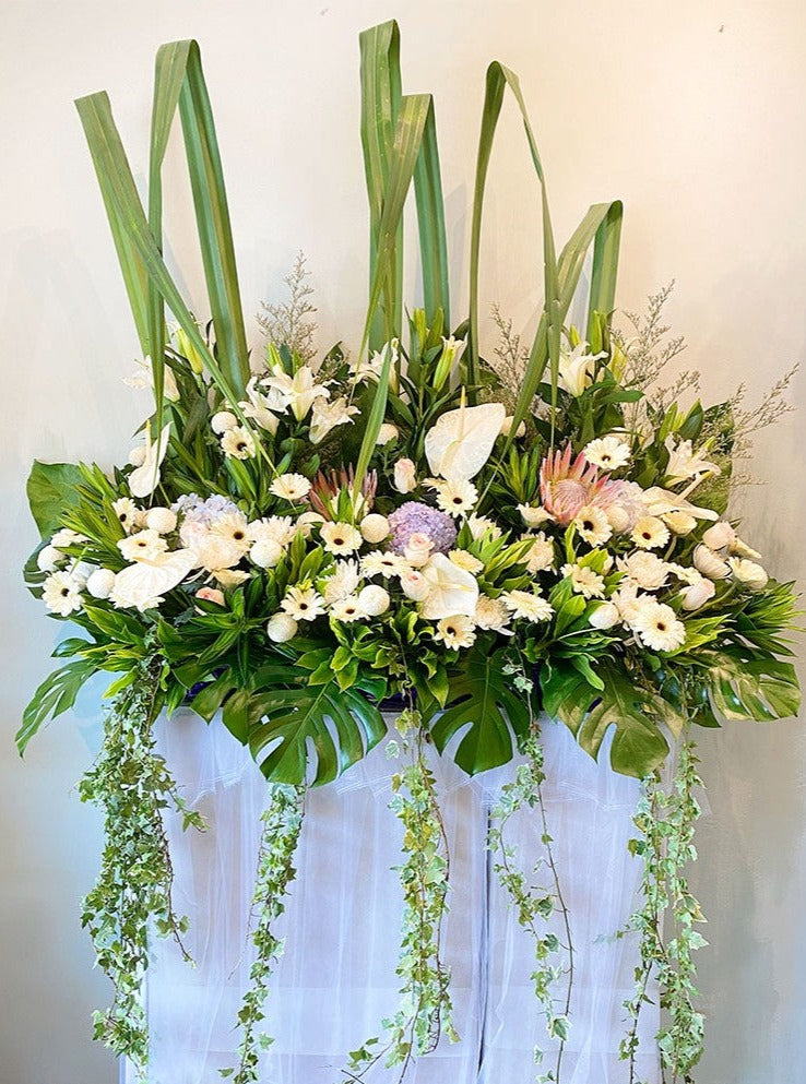 This lovely condolences floral testament to the circle of life and love evokes beautiful memories even during the most difficult times. For same day condolences flowers delivery in Bukit Mertajam.  approximately size: 7 ft (height) x 5.5ft (length)
